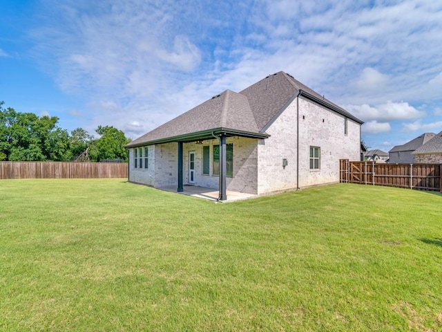 1110 Howley Ct, Forney, TX 75126 - back of property featuring brick siding, a patio area, and roof with shingles