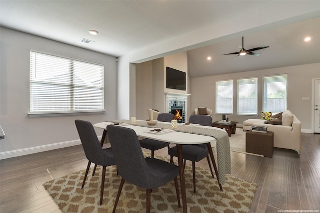 1110 Howley Ct, Forney, TX 75126 - dining room featuring a warm lit fireplace, baseboards, wood finished floors, recessed lighting, and lofted ceiling