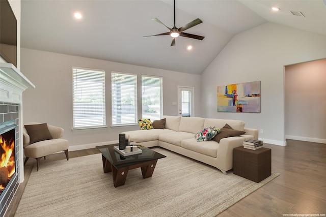1110 Howley Ct, Forney, TX 75126 - living room featuring a lit fireplace, a ceiling fan, baseboards, wood finished floors, and recessed lighting