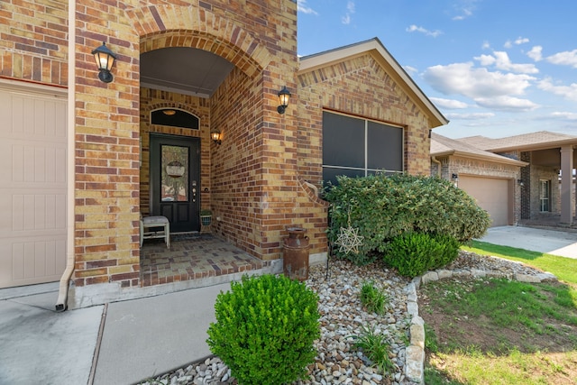 15712 Oak Pointe Dr, Fort Worth, TX 76177 - doorway to property featuring an attached garage, brick siding, and concrete driveway
