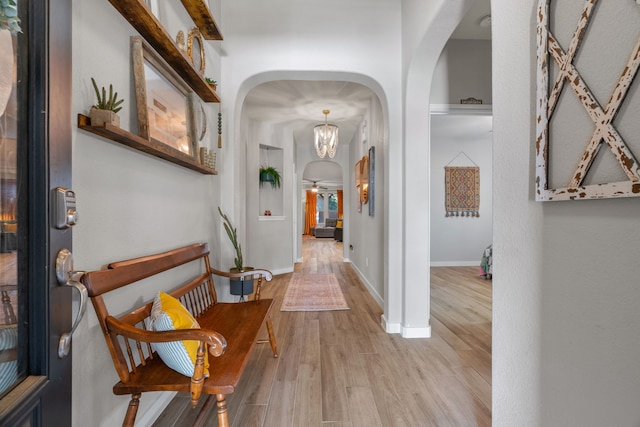 15712 Oak Pointe Dr, Fort Worth, TX 76177 - hallway with arched walkways, wood finished floors, and baseboards