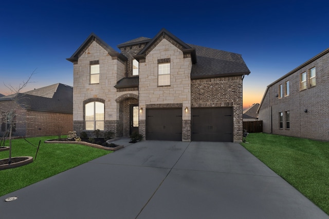 232 Lakewood Ln, Ponder, TX 76259 - french country inspired facade featuring stone siding, concrete driveway, brick siding, and an attached garage