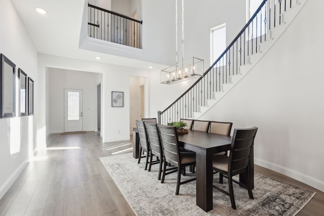 232 Lakewood Ln, Ponder, TX 76259 - dining space with stairway, wood finished floors, a chandelier, a high ceiling, and recessed lighting