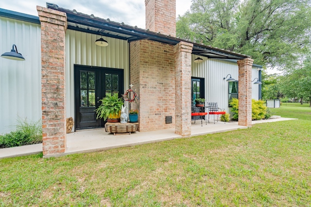 853 County Road 2215, Decatur, TX 76234 - doorway to property featuring french doors, a yard, a chimney, and brick siding