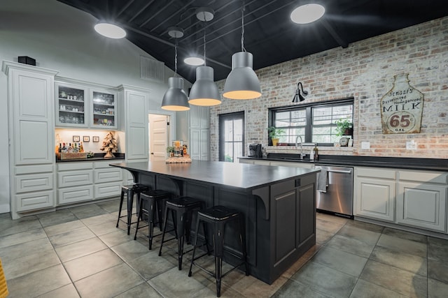 853 County Road 2215, Decatur, TX 76234 - kitchen featuring dishwasher, dark countertops, a center island, a sink, and high vaulted ceiling