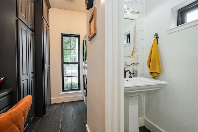 853 County Road 2215, Decatur, TX 76234 - bathroom featuring wood finished floors, healthy amount of natural light, and baseboards
