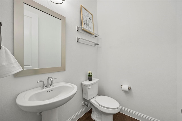 2012 Grover Ln, Rockwall, TX 75087 - half bathroom with baseboards, toilet, wood finished floors, and a sink