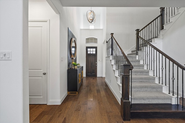 2012 Grover Ln, Rockwall, TX 75087 - foyer featuring stairs, wood finished floors, baseboards, a towering ceiling, and a chandelier