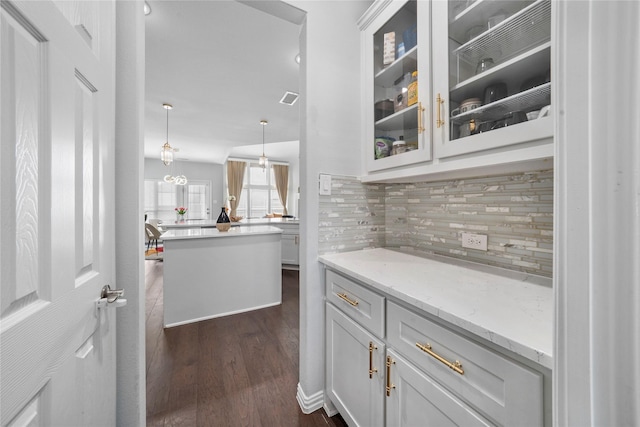 1708 Ordonez Dr, Little Elm, TX 75068 - bar area with dark wood-style floors, decorative backsplash, and pendant lighting