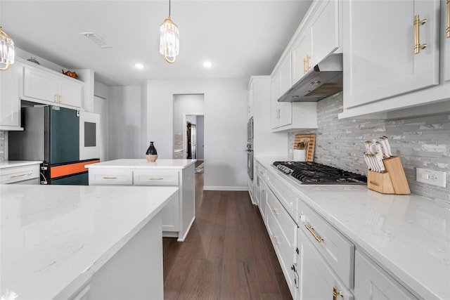 1708 Ordonez Dr, Little Elm, TX 75068 - kitchen featuring under cabinet range hood, appliances with stainless steel finishes, white cabinetry, backsplash, and recessed lighting