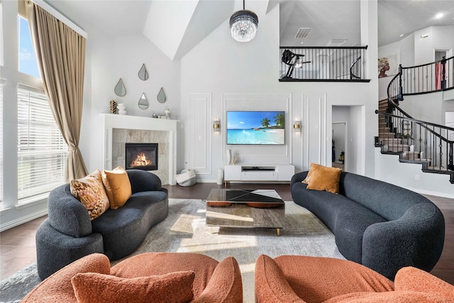 1708 Ordonez Dr, Little Elm, TX 75068 - living room with high vaulted ceiling, stairs, a fireplace, baseboards, and wood finished floors