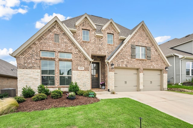 2232 Autrey Ln, Northlake, TX 76247 - view of front of property featuring brick siding, concrete driveway, a front lawn, a garage, and roof with shingles