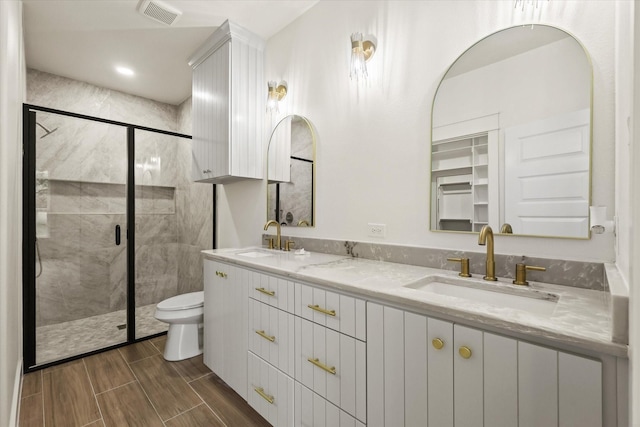 609 N Stewart St, Azle, TX 76020 - bathroom featuring double vanity, a shower stall, toilet, and wood tiled floors