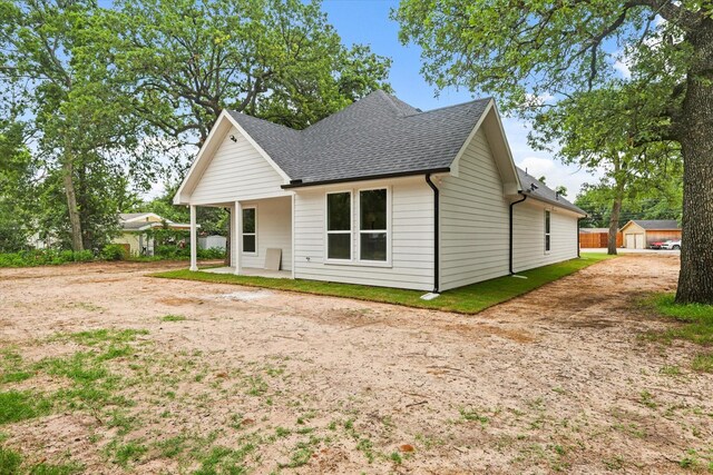 609 N Stewart St, Azle, TX 76020 - view of front of property with roof with shingles, driveway, and an outbuilding