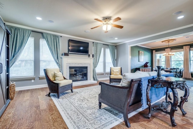 286 Lilac Ln, Southlake, TX 76092 - living room featuring ornamental molding, a ceiling fan, baseboards, a glass covered fireplace, and wood finished floors