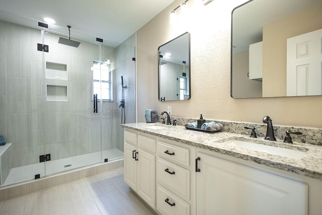 4701 Woodview St, Arlington, TX 76013 - bathroom with a shower stall, double vanity, and tile patterned floors