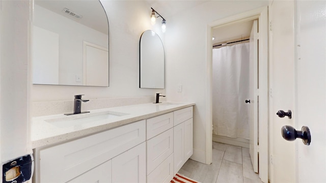 903 Turtle Lake Blvd Unit 268, Irving, TX 75060 - bathroom with double vanity, tile patterned flooring, and a shower with curtain