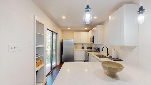 903 Turtle Lake Blvd Unit 268, Irving, TX 75060 - kitchen with appliances with stainless steel finishes, a sink, white cabinets, decorative backsplash, and recessed lighting