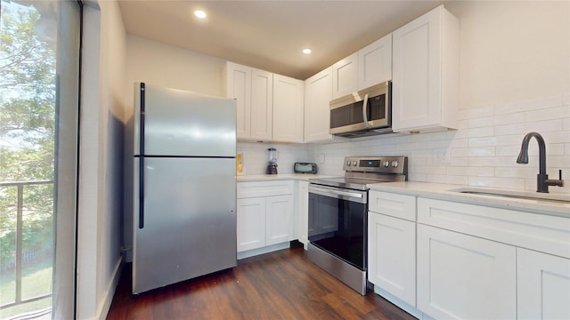 903 Turtle Lake Blvd Unit 268, Irving, TX 75060 - kitchen with appliances with stainless steel finishes, a sink, light countertops, decorative backsplash, and white cabinets