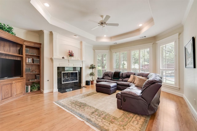 808 Country Club Dr, Heath, TX 75032 - living area featuring a tray ceiling, a ceiling fan, wood finished floors, ornamental molding, and a high end fireplace