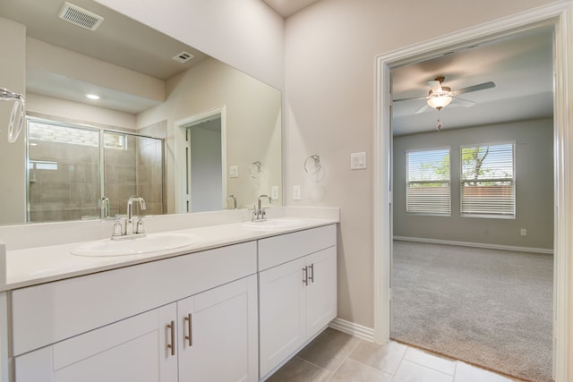 944 Linden Ct, Lavon, TX 75166 - bathroom featuring double vanity, a ceiling fan, a shower stall, baseboards, and tile patterned floors