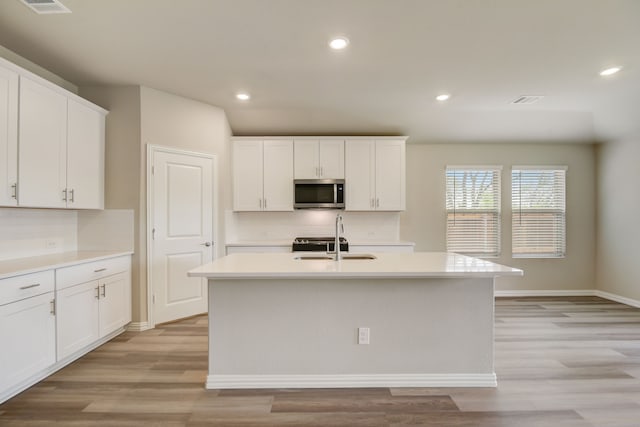 944 Linden Ct, Lavon, TX 75166 - kitchen featuring stainless steel microwave, a sink, tasteful backsplash, light countertops, and recessed lighting