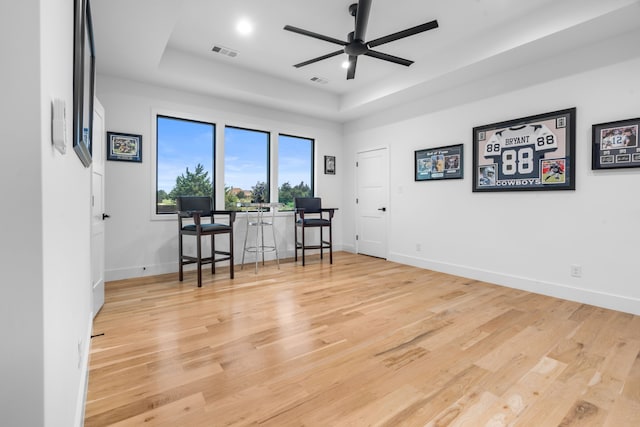 4940 Golden Bell Ln, Midlothian, TX 76065 - interior space featuring a tray ceiling, ceiling fan, light wood-style floors, and baseboards