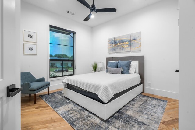 4940 Golden Bell Ln, Midlothian, TX 76065 - bedroom featuring baseboards, light wood-type flooring, and a ceiling fan