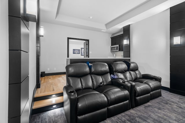 4940 Golden Bell Ln, Midlothian, TX 76065 - cinema room featuring baseboards, a tray ceiling, and wood finished floors