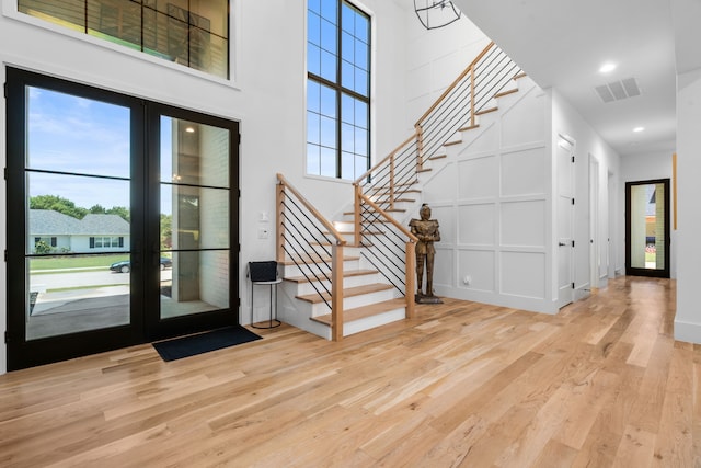 4940 Golden Bell Ln, Midlothian, TX 76065 - entryway featuring stairway, french doors, wood finished floors, plenty of natural light, and a towering ceiling