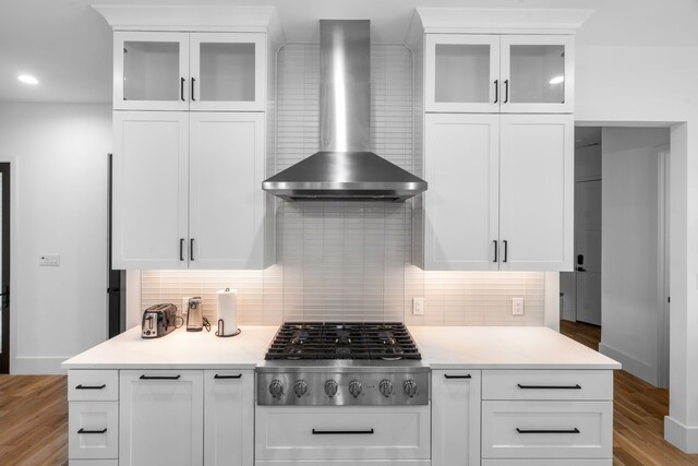 4940 Golden Bell Ln, Midlothian, TX 76065 - kitchen with wall chimney exhaust hood, stainless steel gas cooktop, light wood-type flooring, tasteful backsplash, and recessed lighting
