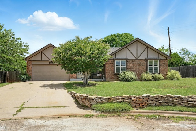 7934 Bonnie Cir, Abilene, TX 79606 - tudor house featuring concrete driveway, brick siding, and a garage