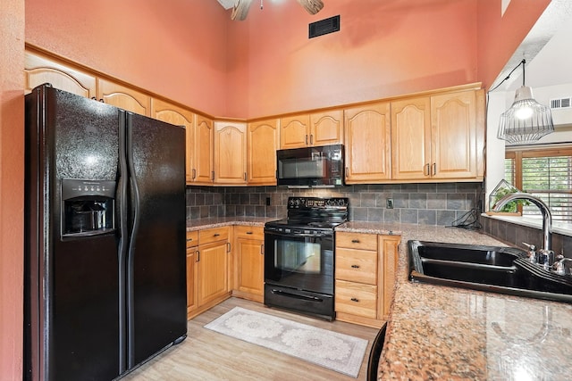 7934 Bonnie Cir, Abilene, TX 79606 - kitchen featuring black appliances, a sink, light brown cabinets, a high ceiling, and backsplash