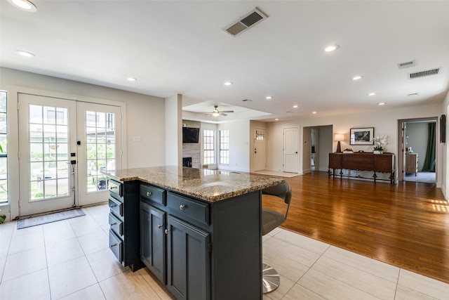 14815 Surveyor Blvd, Addison, TX 75001 - kitchen featuring a ceiling fan, light tile patterned flooring, a center island, recessed lighting, and open floor plan