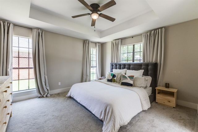 14815 Surveyor Blvd, Addison, TX 75001 - bedroom with a raised ceiling, carpet, baseboards, and a ceiling fan