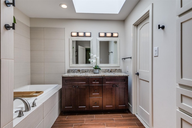 14815 Surveyor Blvd, Addison, TX 75001 - bathroom with a skylight, a bath, double vanity, recessed lighting, and wood tiled floors
