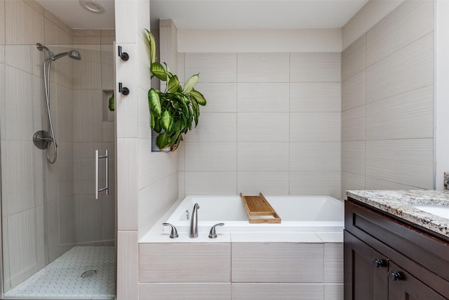 14815 Surveyor Blvd, Addison, TX 75001 - bathroom with vanity, a stall shower, a garden tub, and tile walls