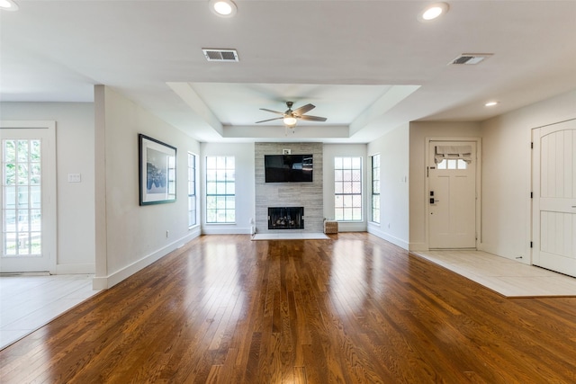 14815 Surveyor Blvd, Addison, TX 75001 - unfurnished living room with baseboards, plenty of natural light, a raised ceiling, a ceiling fan, and recessed lighting