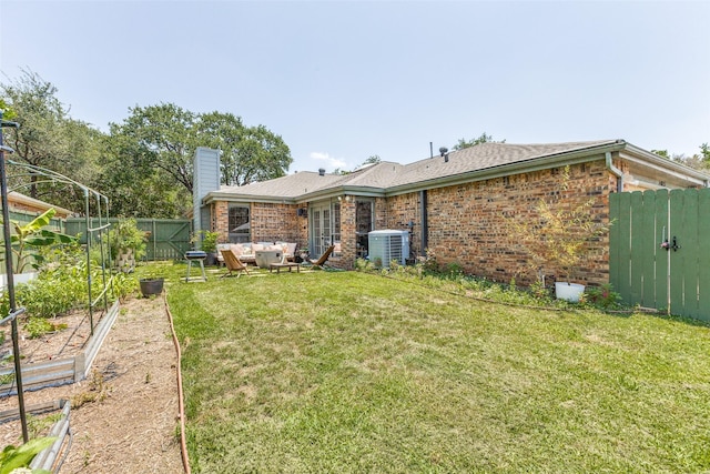 14815 Surveyor Blvd, Addison, TX 75001 - back of house featuring central AC unit, brick siding, a garden, an outdoor living space, and a chimney