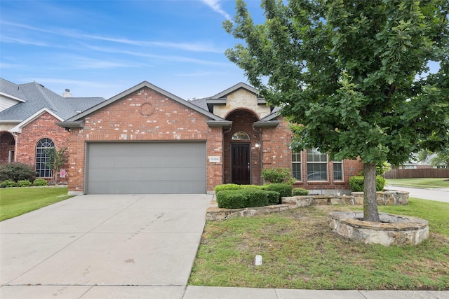 13100 Larks View Pt, Fort Worth, TX 76244 - view of front of property featuring a front lawn, an attached garage, brick siding, and driveway