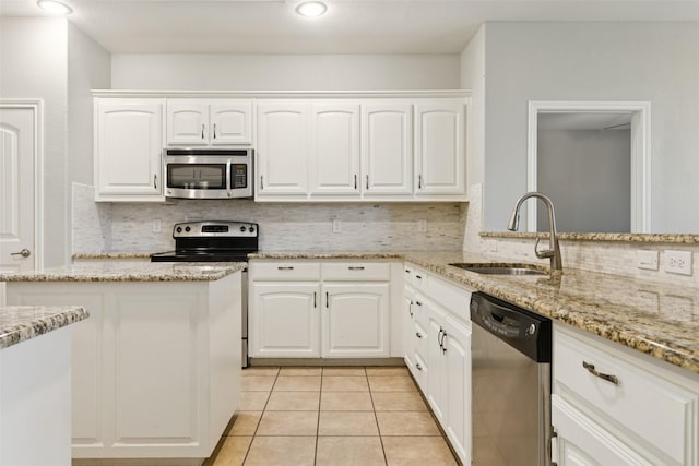 13100 Larks View Pt, Fort Worth, TX 76244 - kitchen featuring stainless steel appliances, a sink, tasteful backsplash, light tile patterned floors, and recessed lighting
