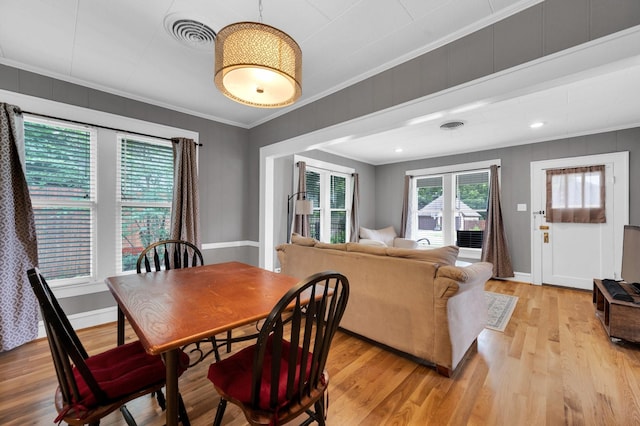 306 W Ross St, Waxahachie, TX 75165 - dining room featuring healthy amount of natural light, light wood-style floors, crown molding, and baseboards