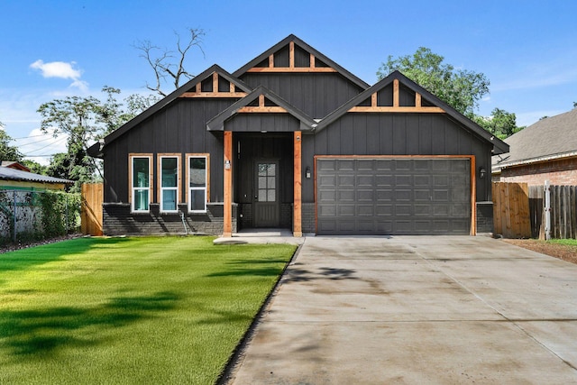 3813 Galvez Ave, Fort Worth, TX 76111 - view of front of home featuring an attached garage, concrete driveway, and board and batten siding
