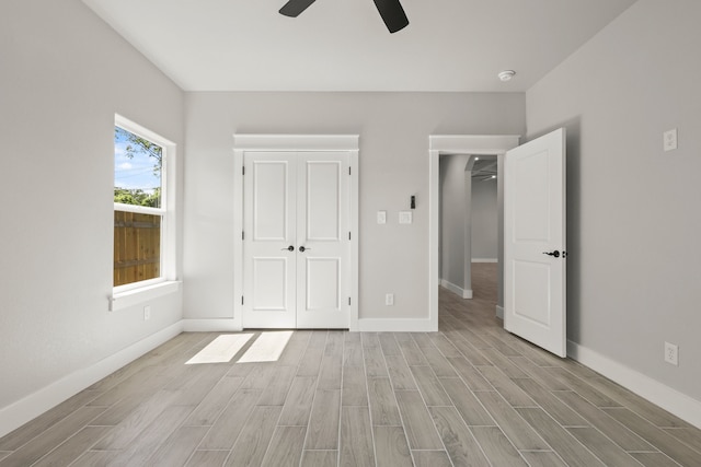 3813 Galvez Ave, Fort Worth, TX 76111 - unfurnished bedroom featuring light wood finished floors, baseboards, and a ceiling fan