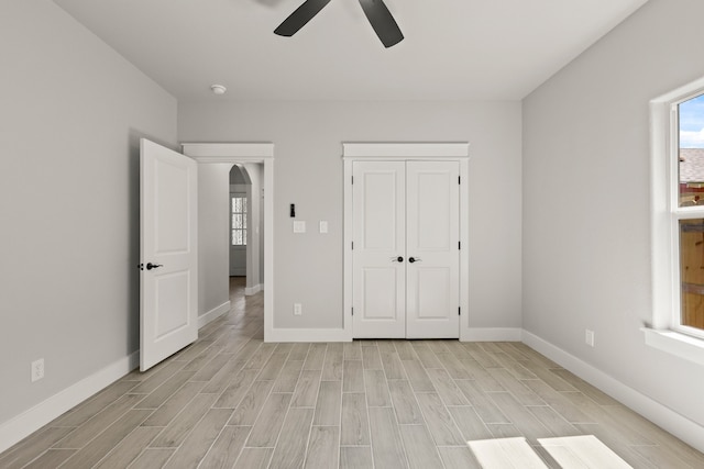 3813 Galvez Ave, Fort Worth, TX 76111 - unfurnished bedroom with light wood-style floors, baseboards, a ceiling fan, and a closet