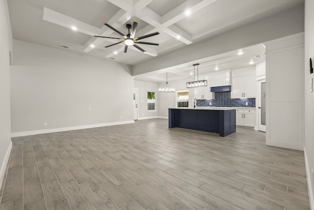 3813 Galvez Ave, Fort Worth, TX 76111 - unfurnished living room with coffered ceiling, recessed lighting, light wood-type flooring, beamed ceiling, and ceiling fan