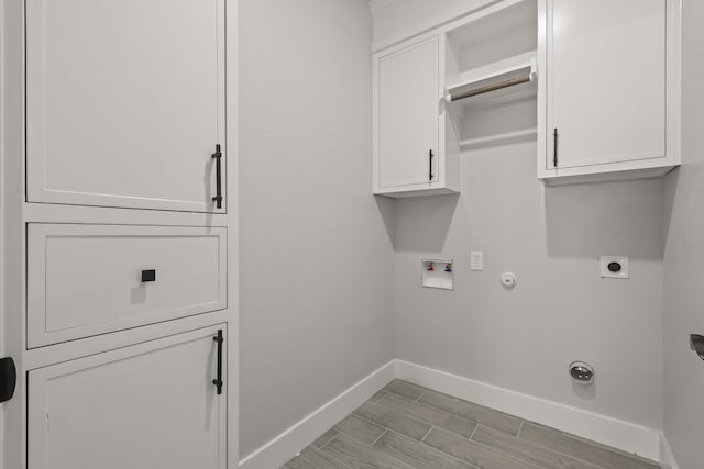 3813 Galvez Ave, Fort Worth, TX 76111 - laundry area featuring electric dryer hookup, baseboards, gas dryer hookup, cabinet space, and hookup for a washing machine