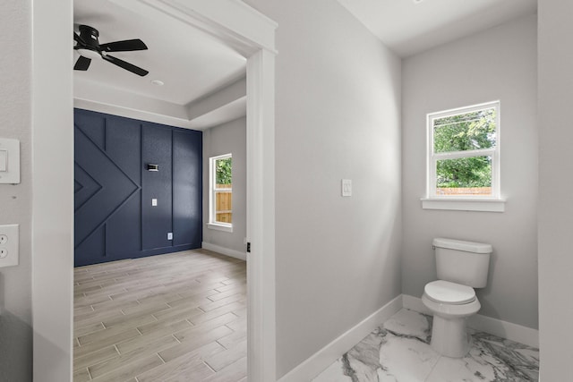 3813 Galvez Ave, Fort Worth, TX 76111 - bathroom featuring baseboards, toilet, plenty of natural light, and a ceiling fan