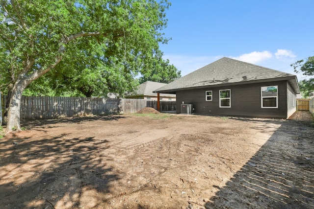 3813 Galvez Ave, Fort Worth, TX 76111 - rear view of house featuring central air condition unit, a fenced backyard, and a shingled roof
