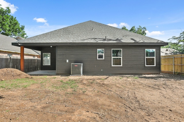3813 Galvez Ave, Fort Worth, TX 76111 - back of property with central AC unit, a shingled roof, and a patio